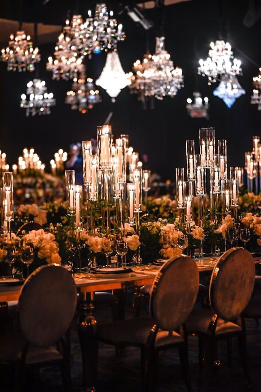 Candelabra tables beneath chandeliers