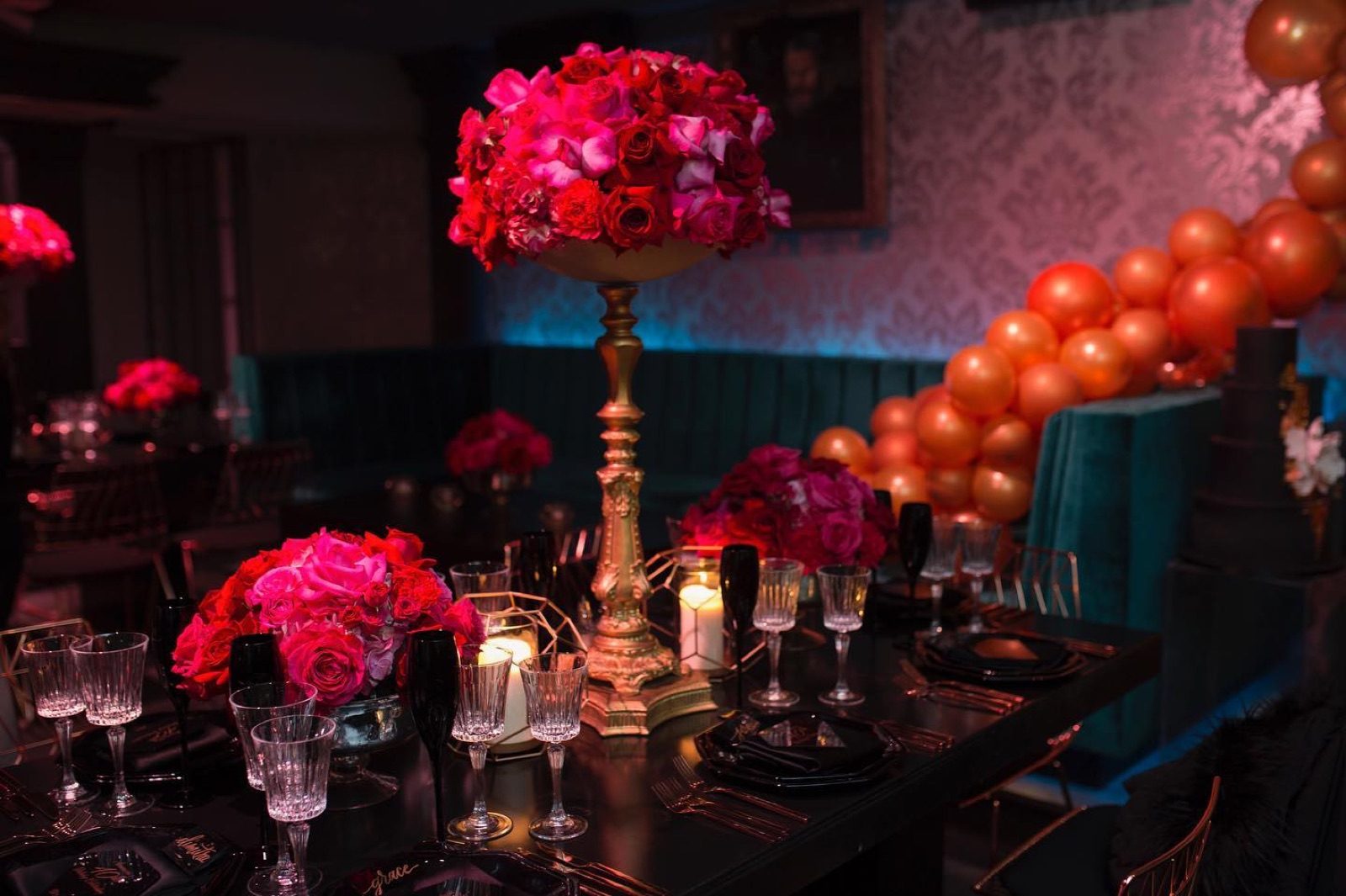 Red centerpiece on a dark gala table