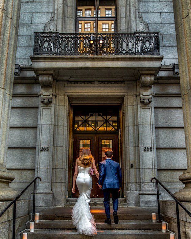 A couple entering a stone townhouse