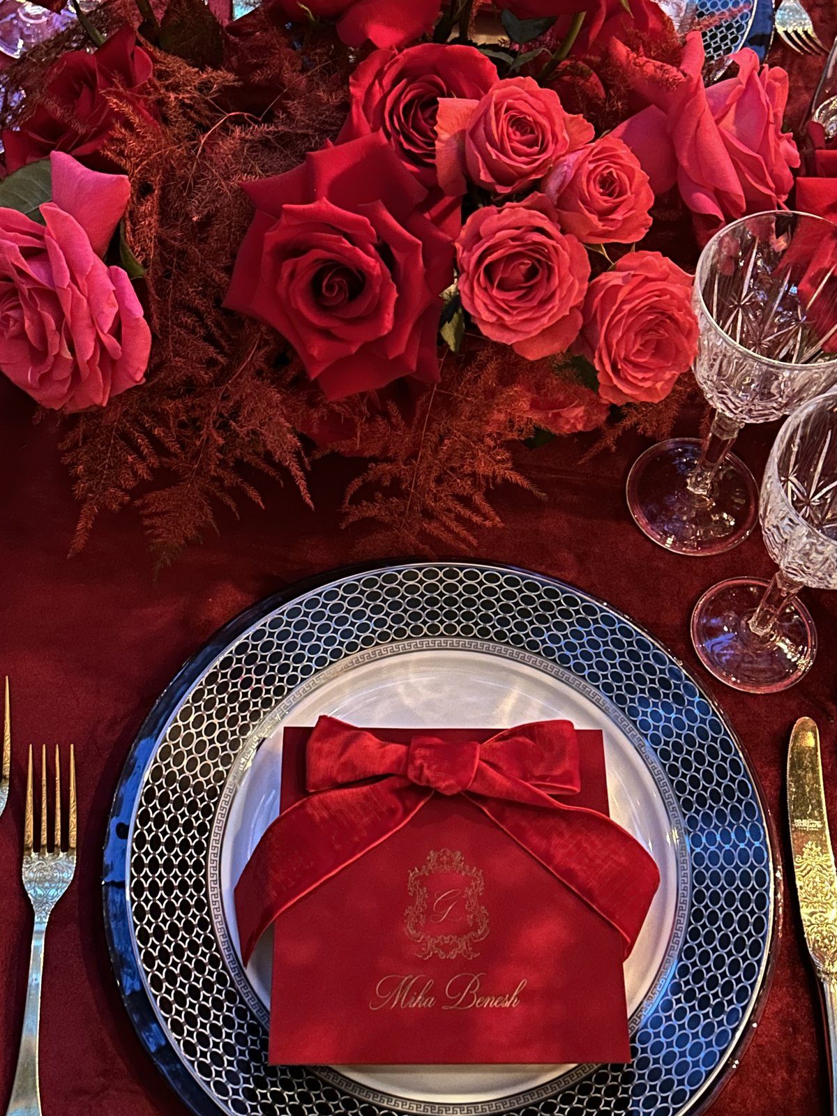 Red roses and a folded menu at a place setting