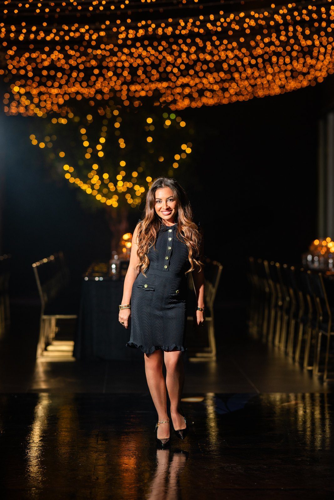 Maddy K beneath a canopy of lights