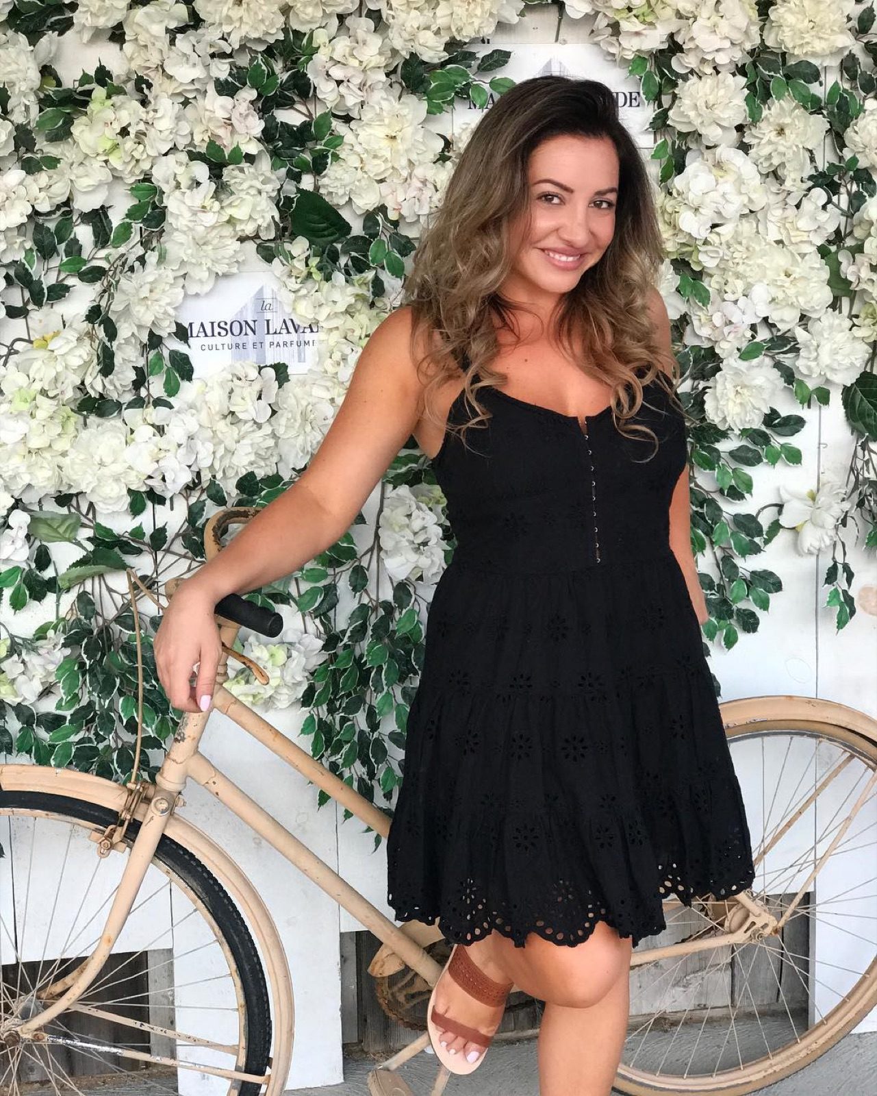 Maddy K by a greenery wall